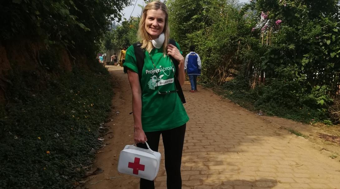 Interns distributing first aid kits to local schools during their public health internship in Madagascar with Projects Abroad. A female intern is pictured whilst distributing first aid kits to local schools during her public health internship in Madagascar.